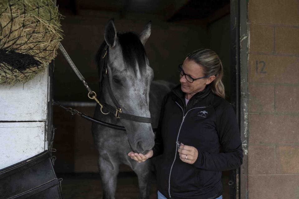 Trainer Jena Antonucci gives a treat to Arcangelo ahead of the Breeders' Cup horse race at Santa Anita Park in Arcadia, Calif., Friday, Oct. 27, 2023. (AP Photo/Jae C. Hong)