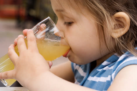 Young girl drinking juice.