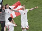 Denmark's Simon Kjaer, right, celebrates victory after the Euro 2020 soccer championship group B match between Russia and Denmark at the Parken stadium in Copenhagen, Denmark, Monday, June 21, 2021. (AP Photo/Hannah McKay, Pool)
