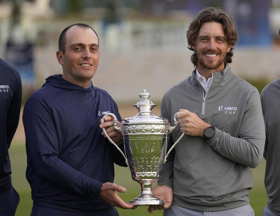 Francesco Molinari, Captain of Continental Europe, left, and Tommy Fleetwood, Captain of Great Britain and Ireland, pose with the trophy, ahead of the first day of the Hero Cup, in Abu Dhabi, United Arab Emirates, Friday, Jan. 13, 2023. (AP Photo/Kamran Jebreili)