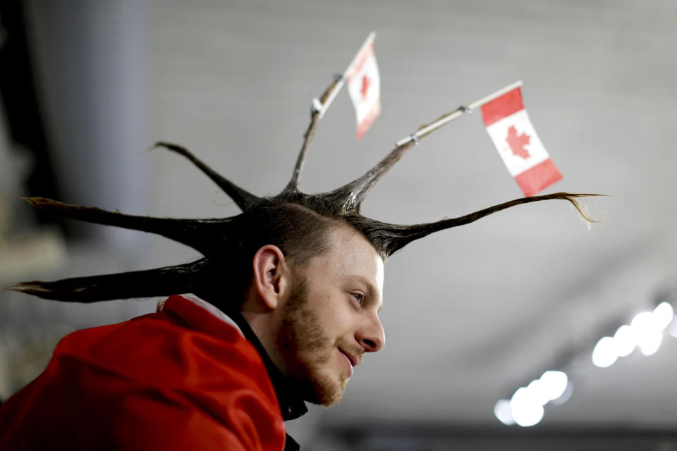 <p>A spectator wearing the Canada flag on his hair watches the mixed doubles semi-final curling match between Russian athletes and Switzerland at the 2018 Winter Olympics in Gangneung, South Korea, Monday, Feb. 12, 2018. (AP Photo/Natacha Pisarenko) </p>