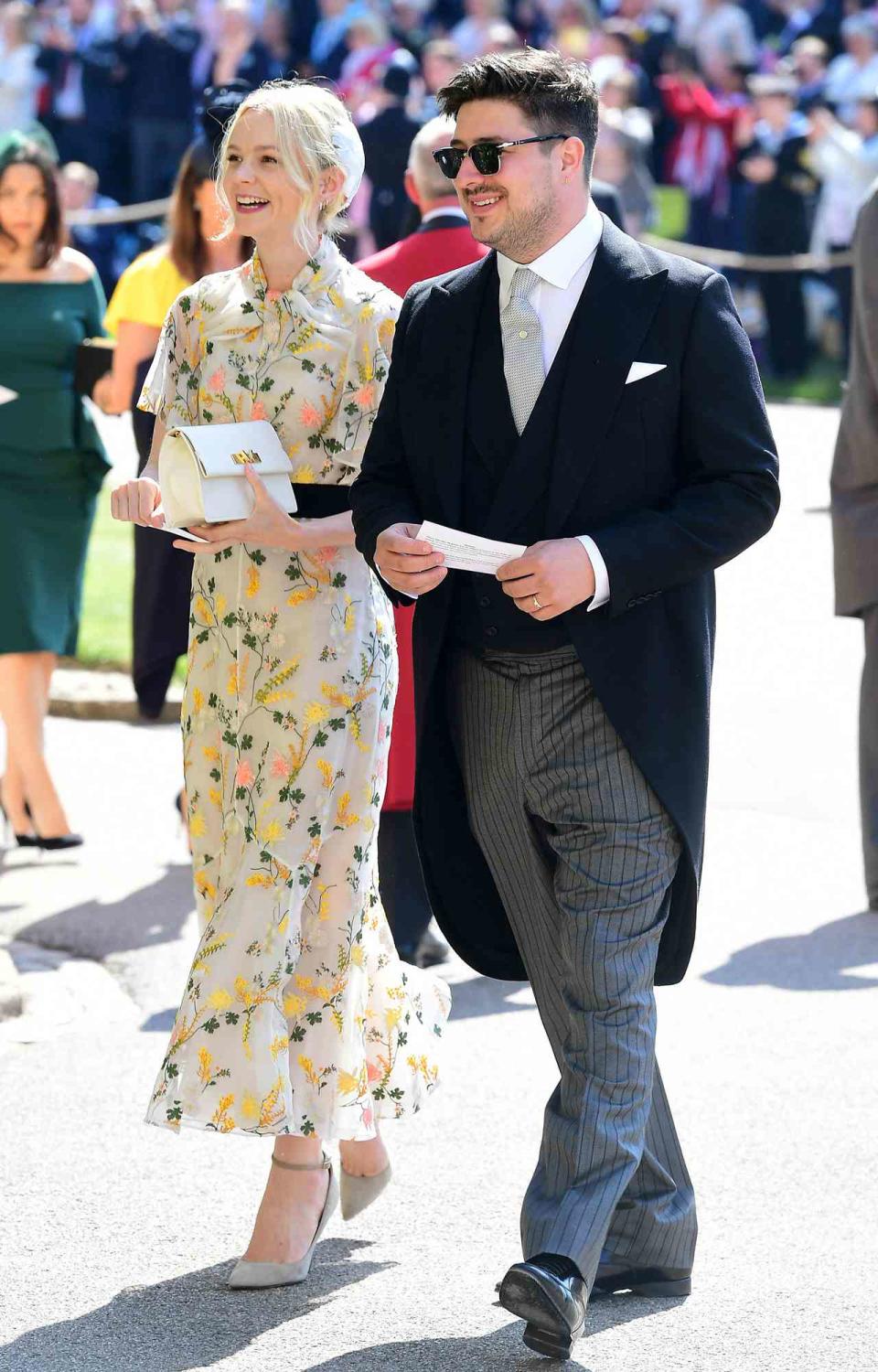 Marcus Mumford and Carey Mulligan arrive at St George's Chapel at Windsor Castle before the wedding of Prince Harry to Meghan Markle on May 19, 2018 in Windsor, England