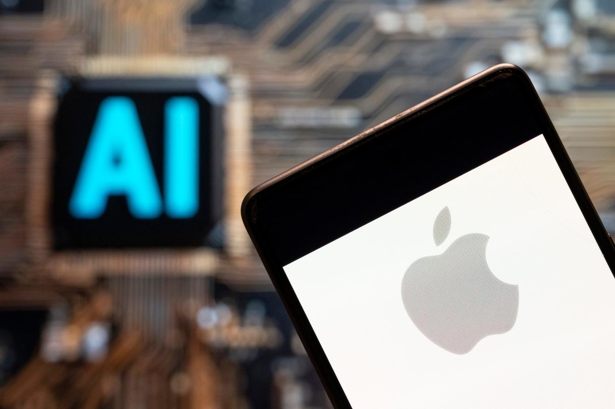 In this photo illustration, the American multinational technology company Apple logo seen displayed on a smartphone with an Artificial intelligence (AI) chip and symbol in the background.