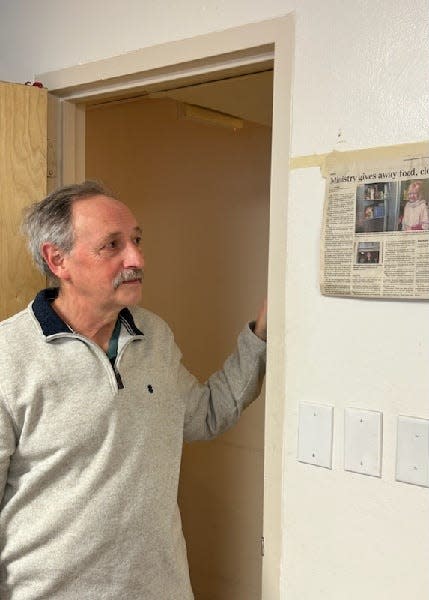 Brian Donnelly stands by a Press & Sun-Bulletin newspaper clipping of a past Faith column about his wife, Barb Donnelly, and Outreach Ministries of the Southern Tier.
