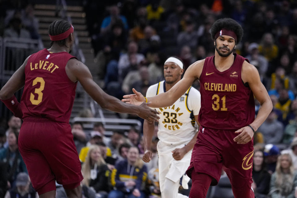 Cleveland Cavaliers center Jarrett Allen (31) is congratulated by guard Caris LeVert (3) after a basket during the second half of an NBA basketball game against the Indiana Pacers in Indianapolis, Monday, March 18, 2024. (AP Photo/Michael Conroy)