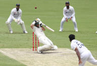 Australia's Marcus Harris hits the ball to be given out during play on day four of the fourth cricket test between India and Australia at the Gabba, Brisbane, Australia, Monday, Jan. 18, 2021. (AP Photo/Tertius Pickard)