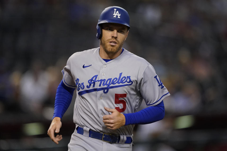 Los Angeles Dodgers' Freddie Freeman (5) scores on a triple hit by Trea Turner during the sixth inning of a baseball game against the Arizona Diamondbacks, Thursday, May 26, 2022, in Phoenix. (AP Photo/Matt York)