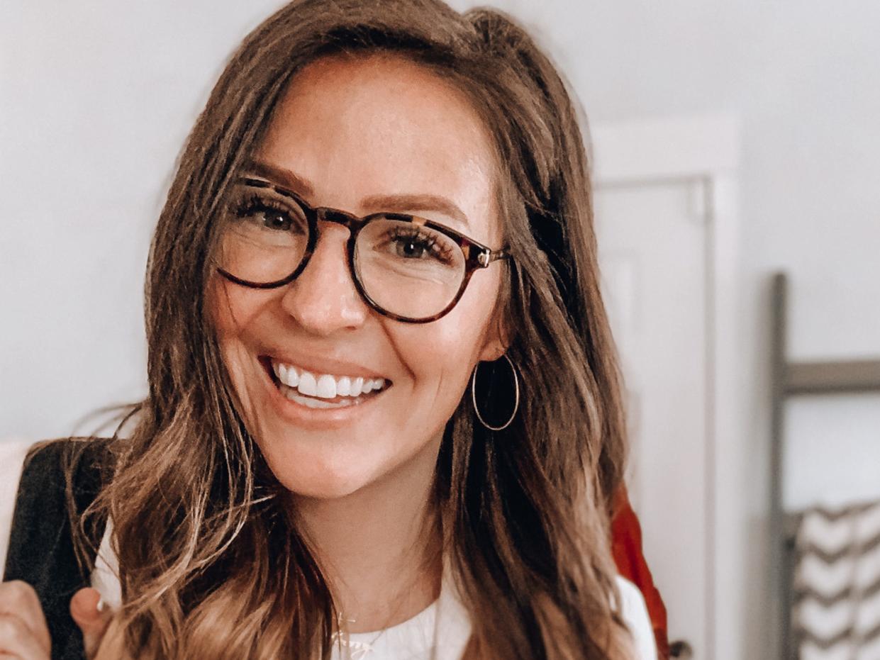 Lauren Burgess with glasses smiling