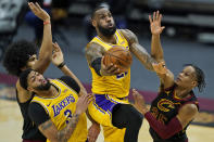 Los Angeles Lakers' LeBron James drives to the basket against Cleveland Cavaliers' Isaac Okoro, right, in the second half of an NBA basketball game, Monday, Jan. 25, 2021, in Cleveland. Jarrett Allen, left, and Anthony Davis watch. The Lakers own 115-108. (AP Photo/Tony Dejak)