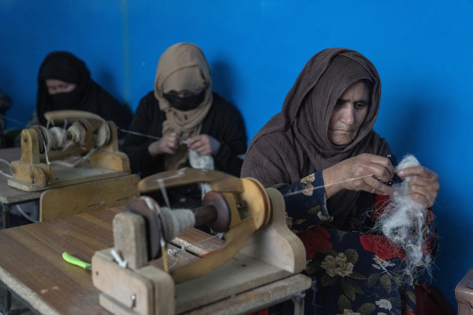 Afghan women weave wools for making carpets at a traditional carpet factory in Kabul, Afghanistan, Monday, March 6, 2023. After the Taliban came to power in Afghanistan, women have been deprived of many of their basic rights. (AP Photo/Ebrahim Noroozi)