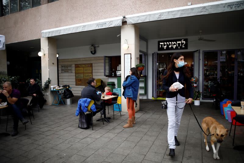 Guests sit and take away food and drinks from a cafe in Tel Aviv