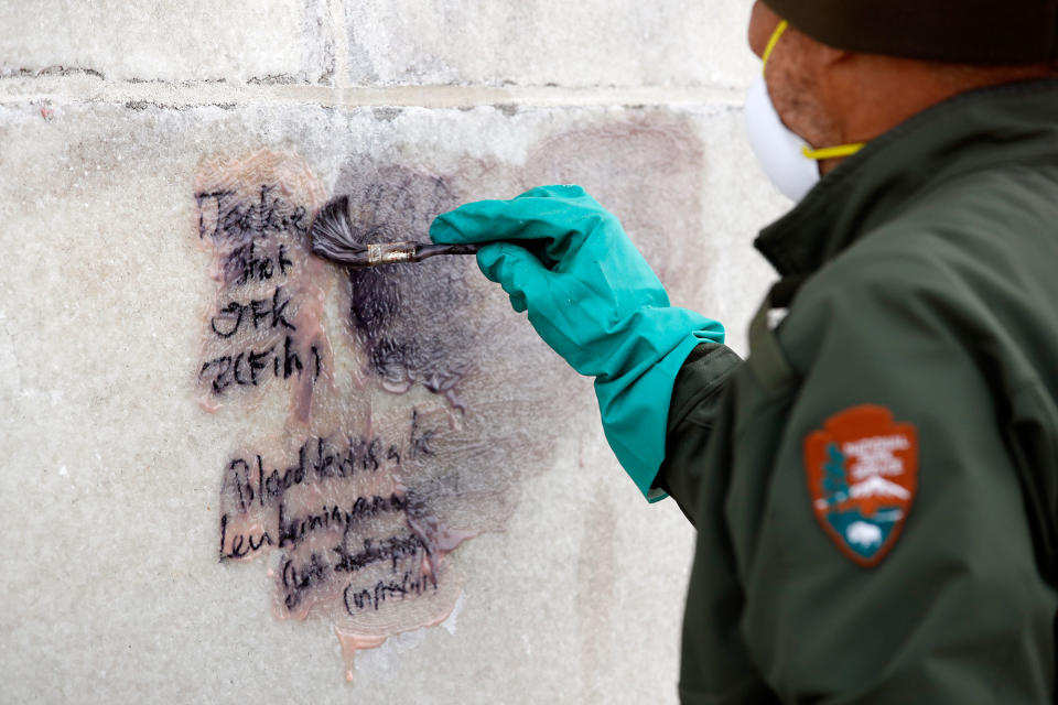 <p>A U.S. Park Service employee works to clean graffiti off of the Washington Monument, Tuesday, Feb. 21, 2017, in Washington. U.S. Park Police spokeswoman Sgt. Anna Rose said that the messages written in permanent marker were discovered over the holiday weekend at the Lincoln Memorial, the Washington Monument and the World War II Memorial. (AP Photo/Alex Brandon) </p>