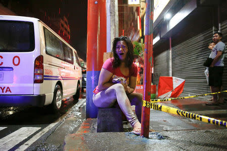 A woman cries after her husband was shot dead by unidentified gunmen riding motorcycles in Manila, Philippines late October 10, 2016. REUTERS/Damir Sagolj/File Photo