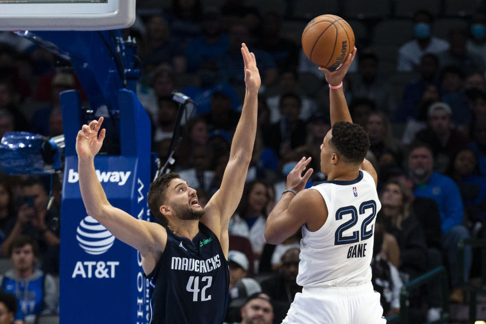 Memphis Grizzlies guard Desmond Bane (22) attempts to shoot as Dallas Mavericks forward Maxi Kleber (42) defends during the second half of an NBA basketball game, Saturday, Dec. 4, 2021, in Dallas. (AP Photo/Sam Hodde)