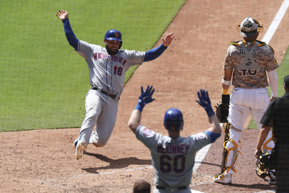 New York Mets' Jose Peraza slides into home scoring on a double hit by Marcus Stroman off San Diego Padres relief pitcher Craig Stammen in the seventh inning of a baseball game Sunday, June 6, 2021, in San Diego. (AP Photo/Derrick Tuskan)