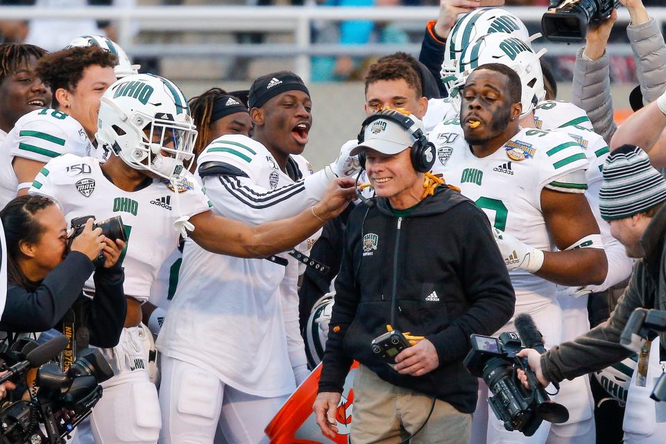 Ohio head coach Frank Solich laughs as players pick and snack on French fries at the end of the Famous Idaho Potato Bowl NCAA college football game against Nevada, Friday, Jan. 3, 2020, in Boise, Idaho. Ohio 30-21. (AP Photo/Steve Conner)