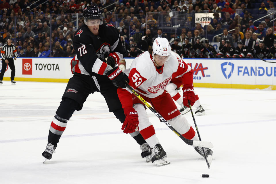 Detroit Red Wings defenseman Moritz Seider (53) is stick-checked by Buffalo Sabres center Tage Thompson (72) during the first period of an NHL hockey game Thursday, Dec. 29, 2022, in Buffalo, N.Y. (AP Photo/Jeffrey T. Barnes)