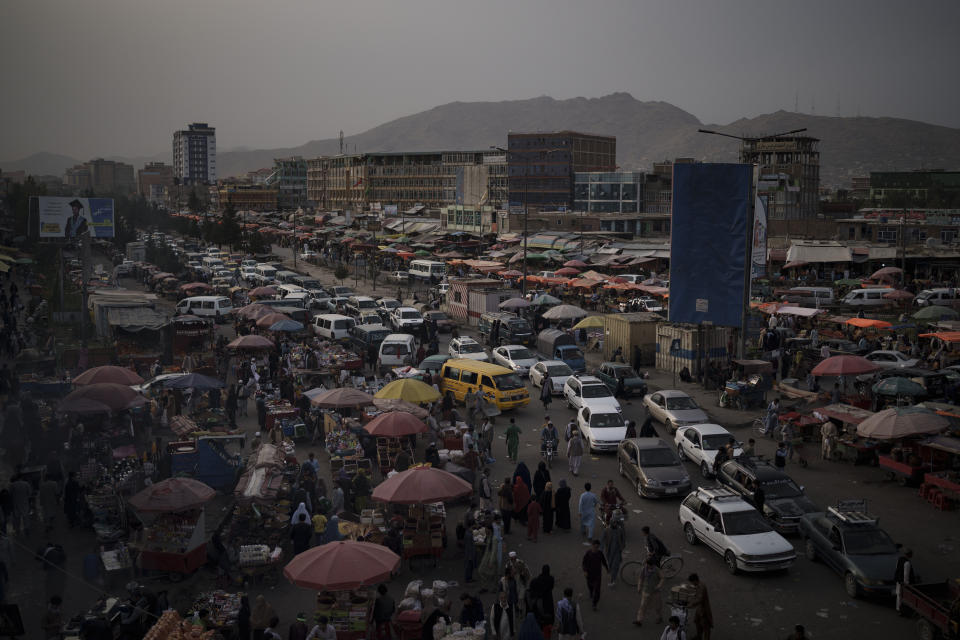 Cars wait in traffic as Afghans shop in a local market in Kabul, Afghanistan, Saturday, Sept. 11, 2021. (AP Photo/Felipe Dana)