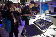 An electronics industry affiliate photographs Dell's XPS Ultrabook convertible at the Consumer Electronics Show.