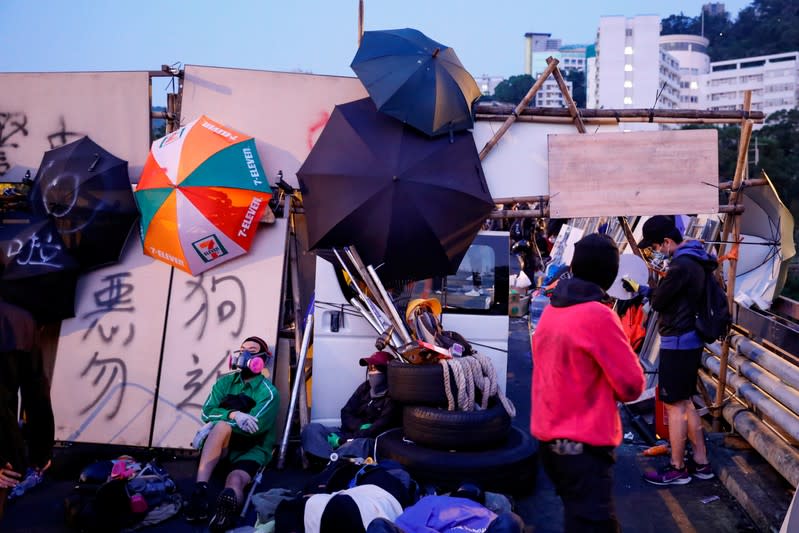 Anti-government protesters scout at a makeshift gate during a standoff with riot police at the Chinese University of Hong Kong, Hong Kong