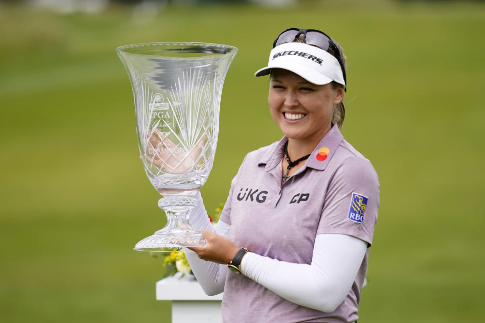 Brooke M. Henderson, of Canada, holds the trophy after winning the ShopRite LPGA Classic golf tournament, Sunday, June 12, 2022, in Galloway, N.J. (AP Photo/Matt Rourke)
