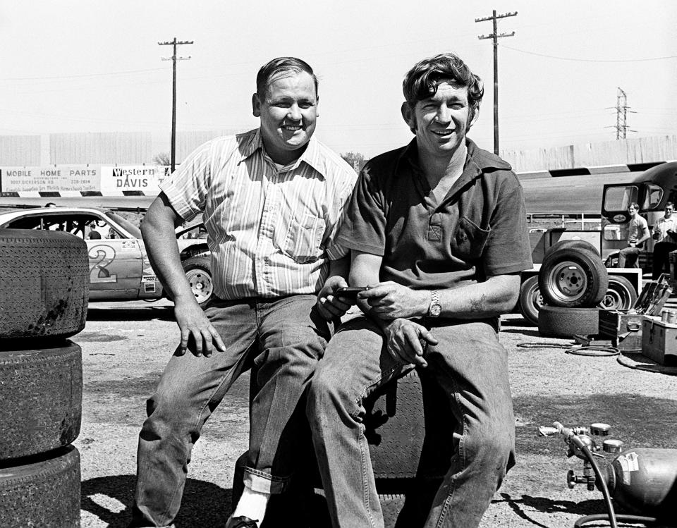 Flookie Buford, left, the defending Fairgrounds Speedway point champion, and top driver Donnie Allison check the time of other drivers during time trials for the Permatex 200 at the track April 22, 1972.