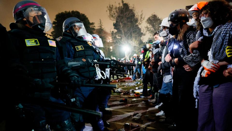 PHOTO: Police face-off with pro-Palestinian students after destroying part of the encampment barricade on the campus of the University of California, Los Angeles (UCLA) in Los Angeles, May 2, 2024. (Etienne Laurent/AFP via Getty Images)