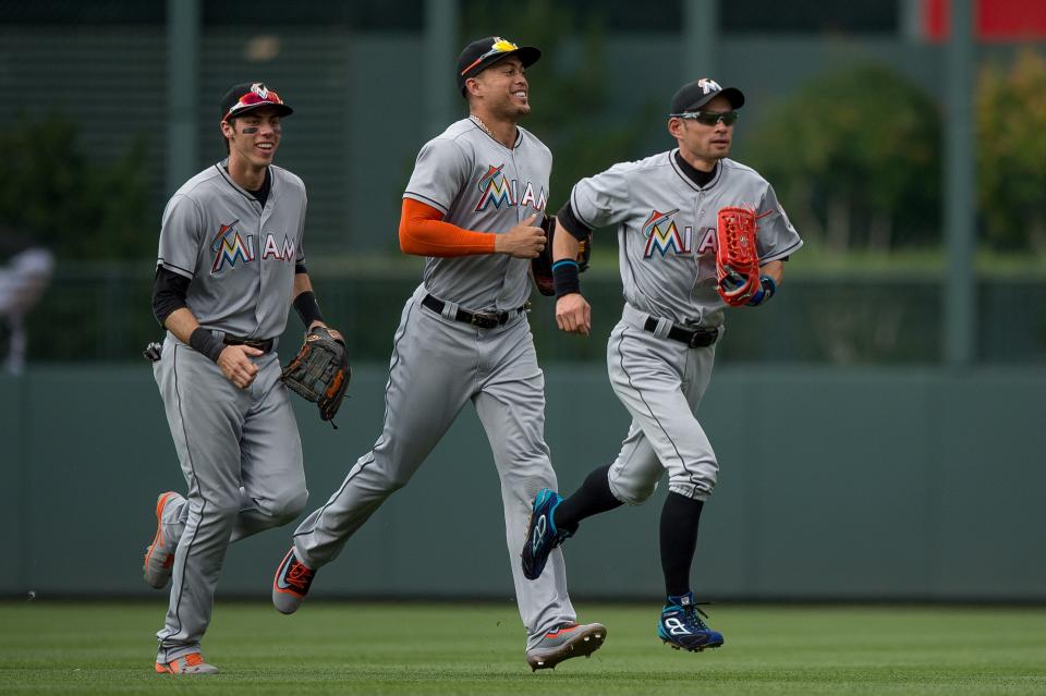 Yelich (left) can say he patrolled the same outfield as Giancarlo Stanton (center) and Ichiro (right)