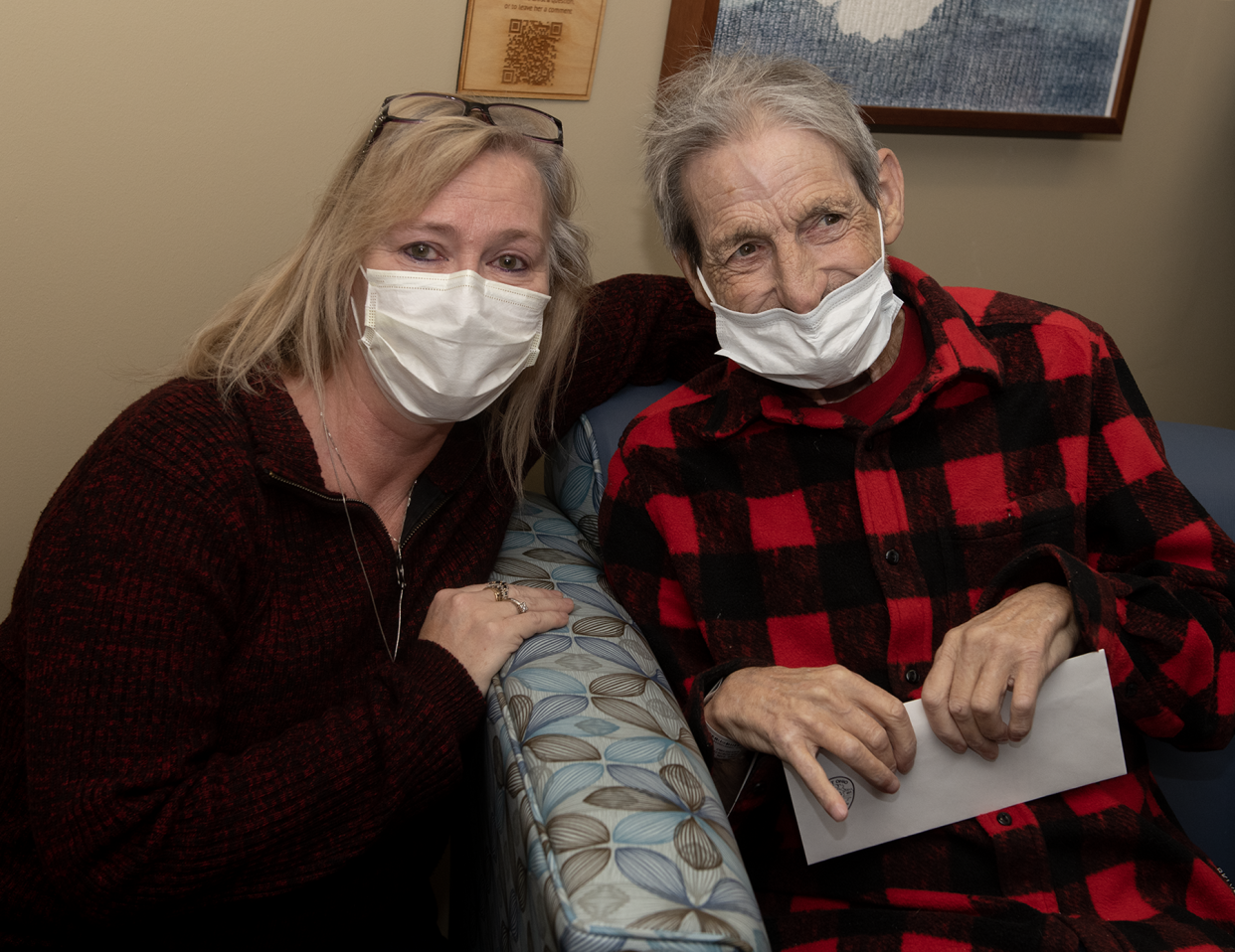 Kent resident Carl Fike with his niece Denise Ficzeri. Fike is holding a $500 check he received at UH Portage Medical Center's Seidman Cancer Center on Wednesday from the Kent Police Department through in initiative to help local cancer patients.