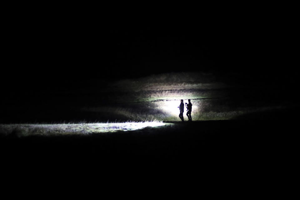 Police officers patrol on a beach near Calais, northern France, on Saturday, Feb. 01, 2020. Britain officially leaves the European Union on Friday. (AP Photo/Thibault Camus)