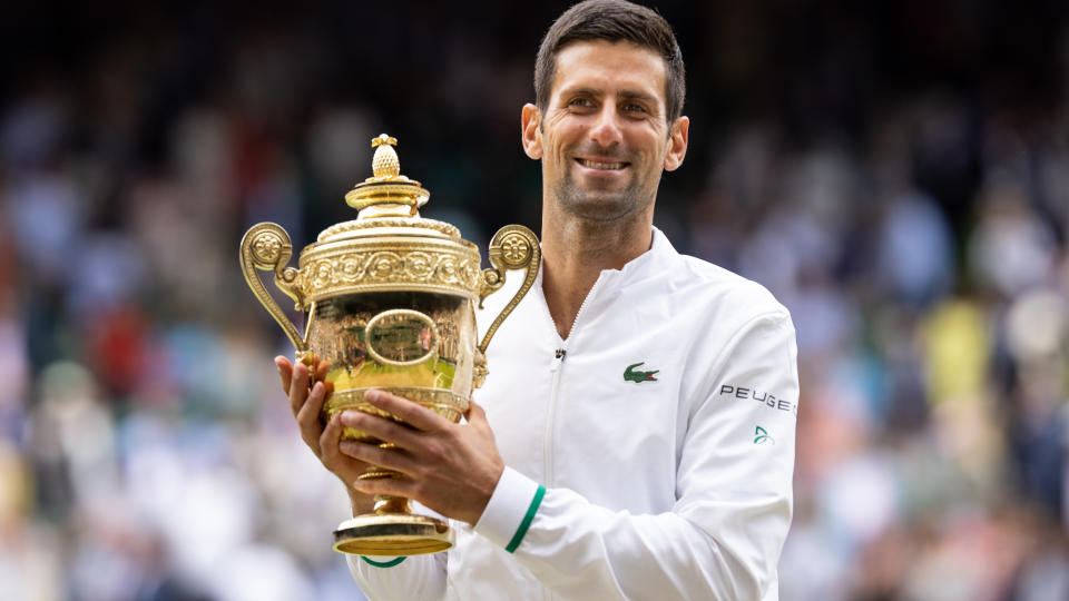 Seen here, Novak Djokovic holds up the 2021 Wimbledon trophy after winning the final against Matteo Berrettini.