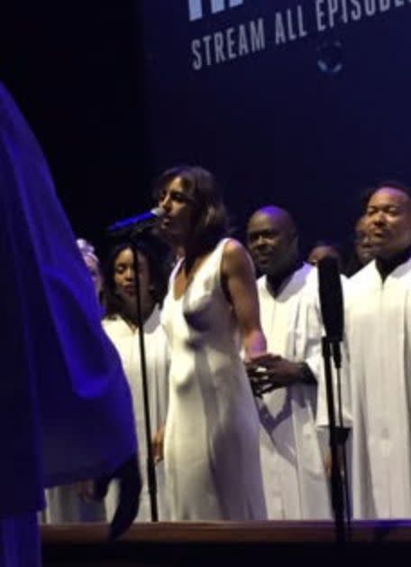 The author sings her song about The Man with a gospel choir at the 