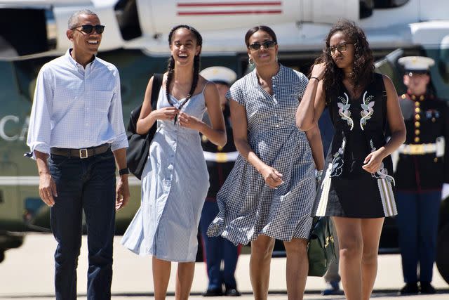 BRENDAN SMIALOWSKI/AFP via Getty From left: Barack, Michelle, Sasha, and Malia Obama