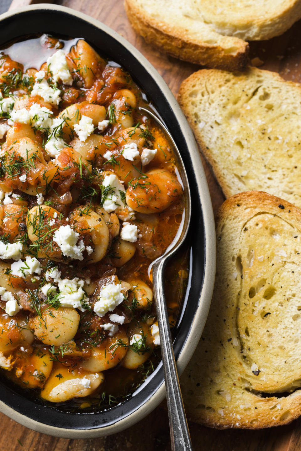 This image released by Milk Street shows a recipe for Butter Beans in Tomato Sauce. (Milk Street via AP)