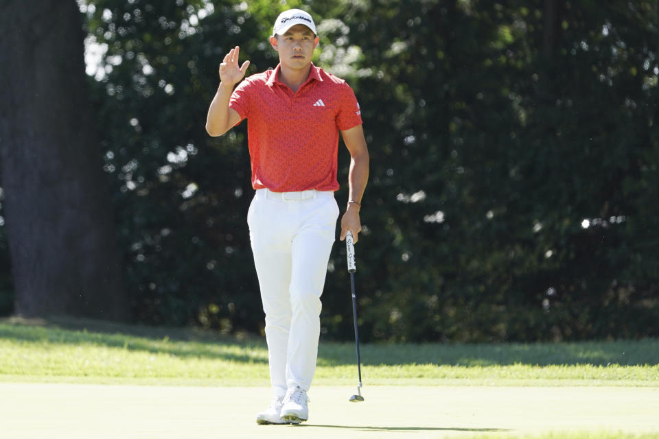 CORRECTS TO COLLIN MORIKAWA, NOT SPAUN - Collin Morikawa of the United States acknowledges audience members on the fourth green in the final round of the PGA Tour Zozo Championship at the Narashino Country Club in Inzai on the outskirts of Tokyo, Sunday, Oct. 22, 2023. (AP Photo/Tomohiro Ohsumi)