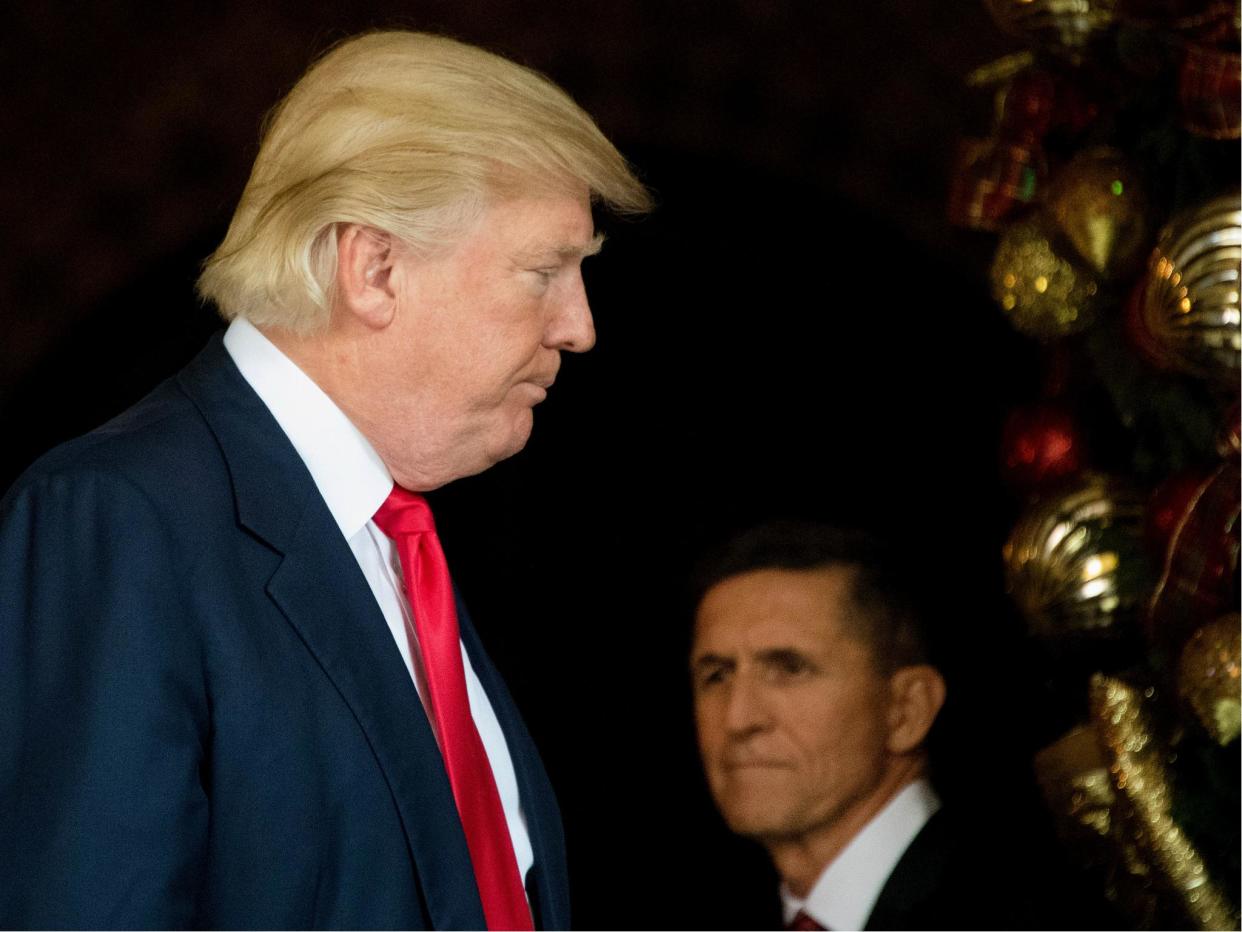 US Presiden Donald Trump stands with former National Security Adviser Michael Flynn at Mar-a-Lago in Palm Beach, Florida on 21 December 2016: JIM WATSON/AFP/Getty Images