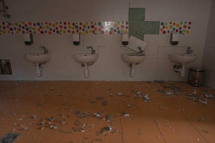 Damages seen in the bathroom of a kindergarten in the aftermath of Russian missile strikes fired toward Kyiv early Sunday, where a crater pocked the courtyard, in Kyiv, Ukraine, Monday, June 27, 2022. (AP Photo/Nariman El-Mofty)