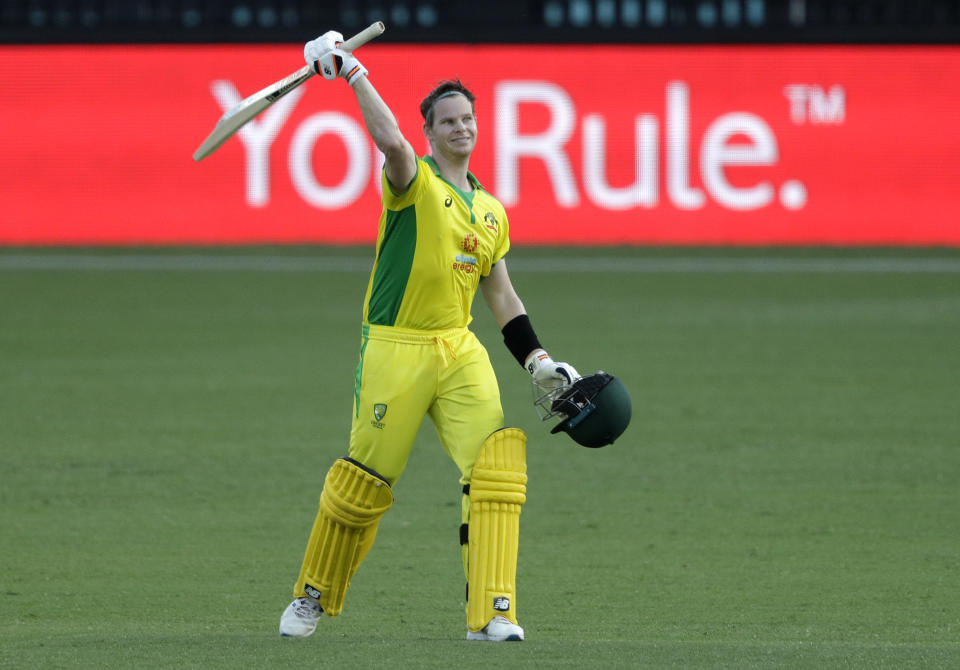 Australia's Steve Smith celebrates after scoring a century during the one day international cricket match between India and Australia at the Sydney Cricket Ground in Sydney, Australia, Friday, Nov. 27, 2020. (AP Photo/Rick Rycroft)