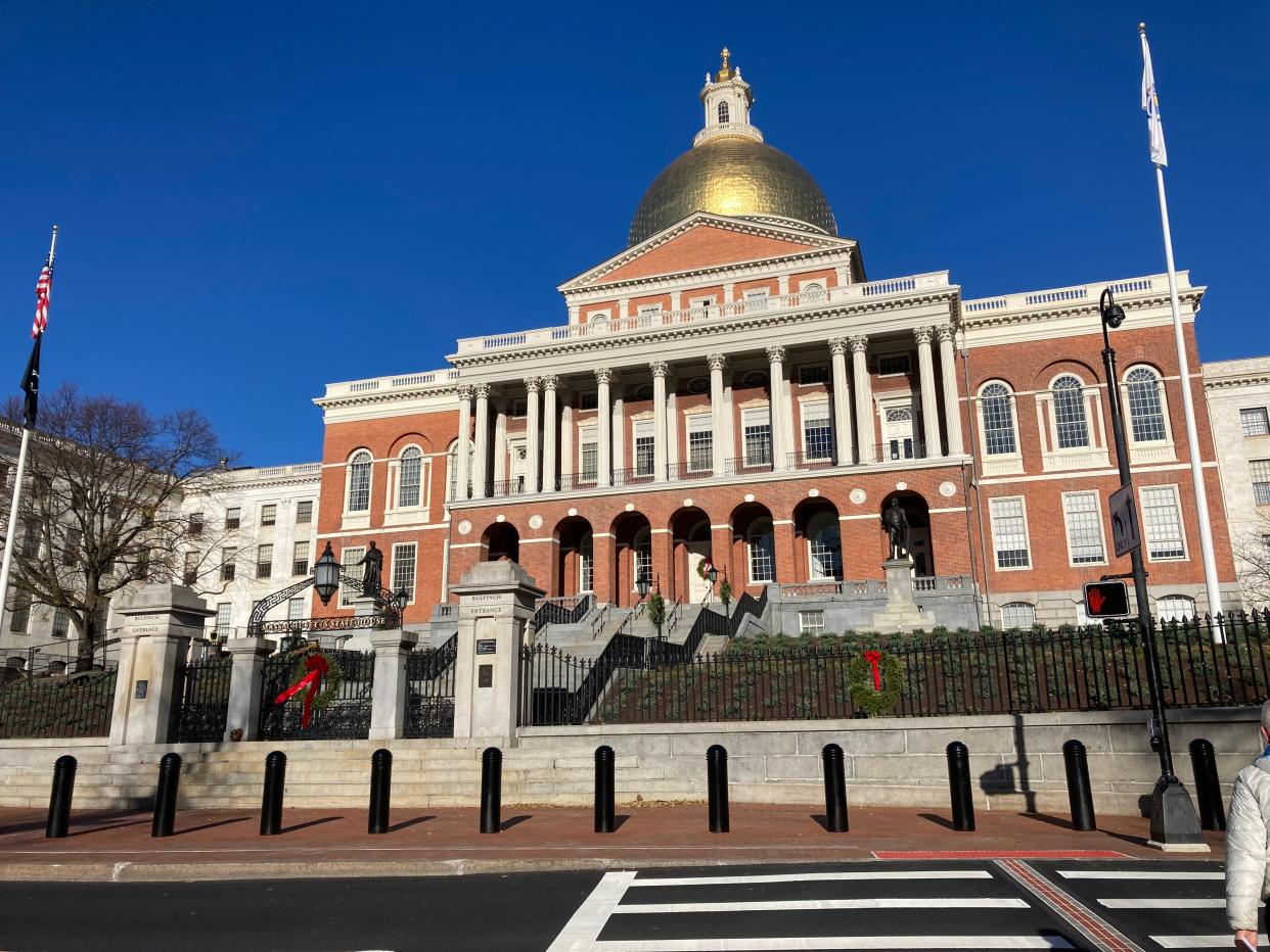 The Massachusetts Statehouse is dressed for the season with holiday wreaths and bows.