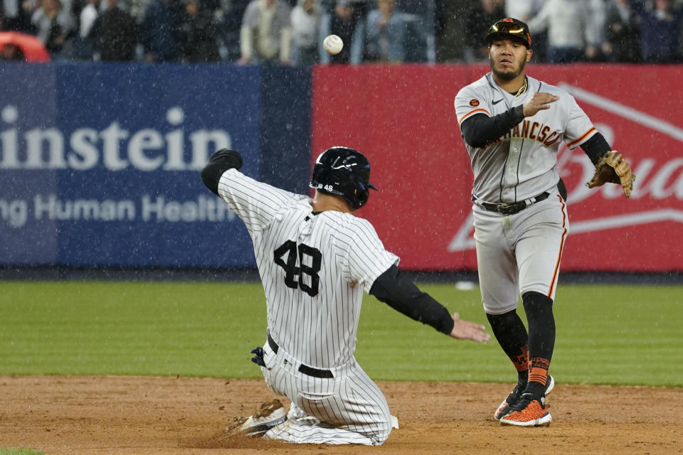 San Francisco Giants second baseman Thairo Estrada, right, throws to first to complete a double play after forcing out New York Yankees' Anthony Rizzo (48) in the ninth inning of a baseball game, Saturday, April 1, 2023, in New York. (AP Photo/Mary Altaffer)