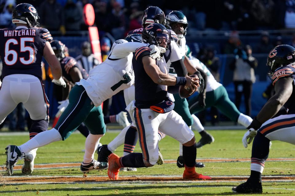 Chicago Bears' Justin Fields is tackled by Philadelphia Eagles' Haason Reddick during the first half Sunday, Dec. 18, 2022, in Chicago.