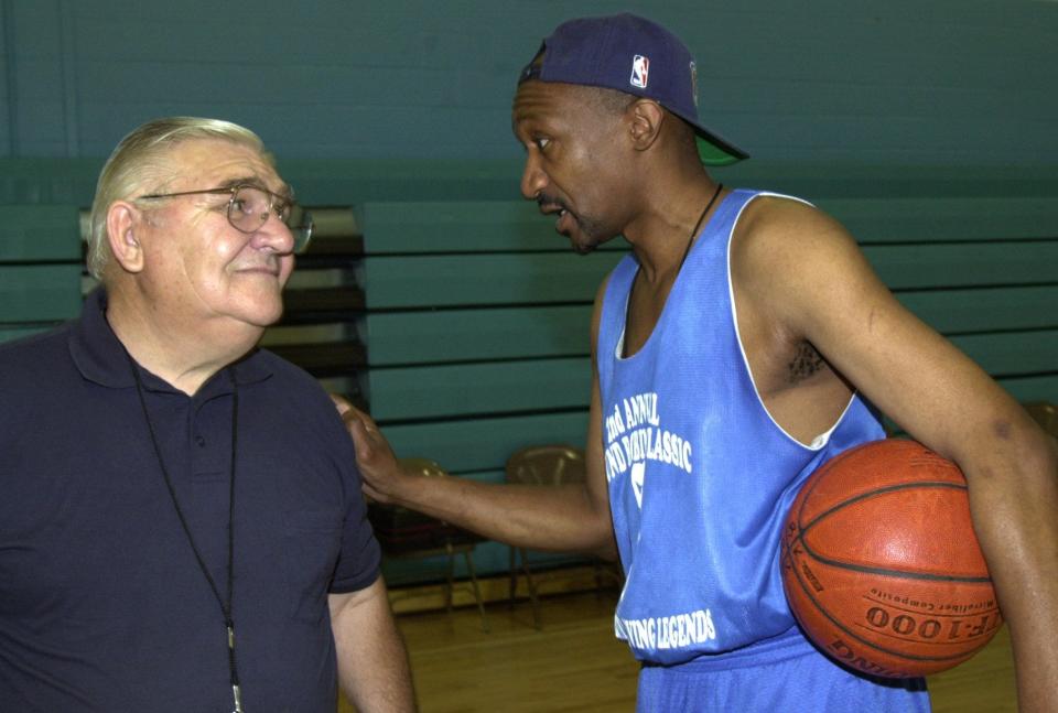 Ed Nietopski and Glenn Hagan talk during a basketball camp.