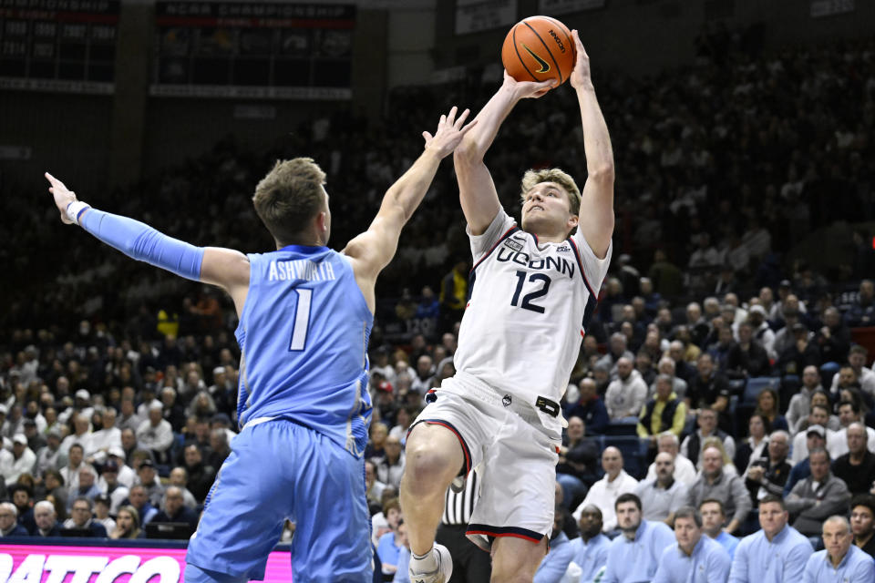 UConn guard Cam Spencer (12) shoots over Creighton guard Steven Ashworth (1) in the first half of an NCAA college basketball game, Wednesday, Jan. 17, 2024, in Stores, Conn. (AP Photo/Jessica Hill)