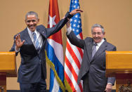 FILE - In this March 21, 2016 file photo, Cuban President Raul Castro, right, lifts up the arm of U.S. President Barack Obama at the conclusion of their joint news conference at the Palace of the Revolution in Havana, Cuba. While Raul has been the face of communist Cuba, its defiance of U.S. efforts to oust its socialist system and its efforts to forge a rapprochement with its longtime foe for the past decade, he formally announced on Friday, April 16, 2021 that he'd step down as head of the Communist Party, leaving Cuba without a Castro in an official position of command for the first time in more than six decades. (AP Photo/Ramon Espinosa, File)