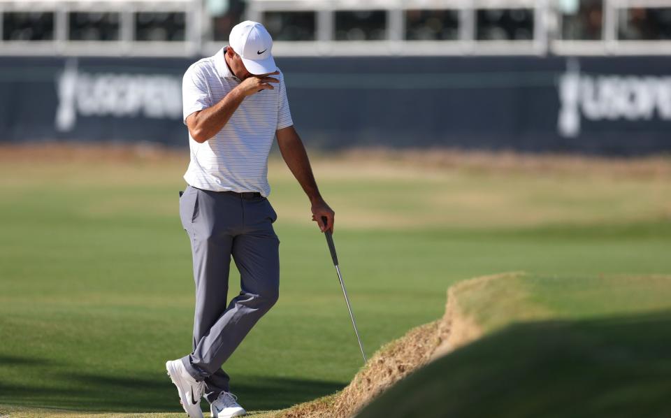 Scottie Scheffler of the United States reacts on the 15th green during the second round