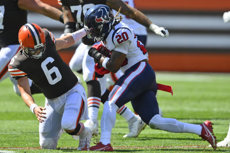 Cleveland Browns quarterback Baker Mayfield (6) is hurt trying to tackle Houston Texans strong safety Justin Reid (20) during the first half of an NFL football game, Sunday, Sept. 19, 2021, in Cleveland. (AP Photo/David Richard)