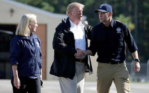 President Donald Trump with FEMA Administrator Brock Long and Homeland Security Secretary Kirstjen Nielsen  - Credit:  Evan Vucci/AP