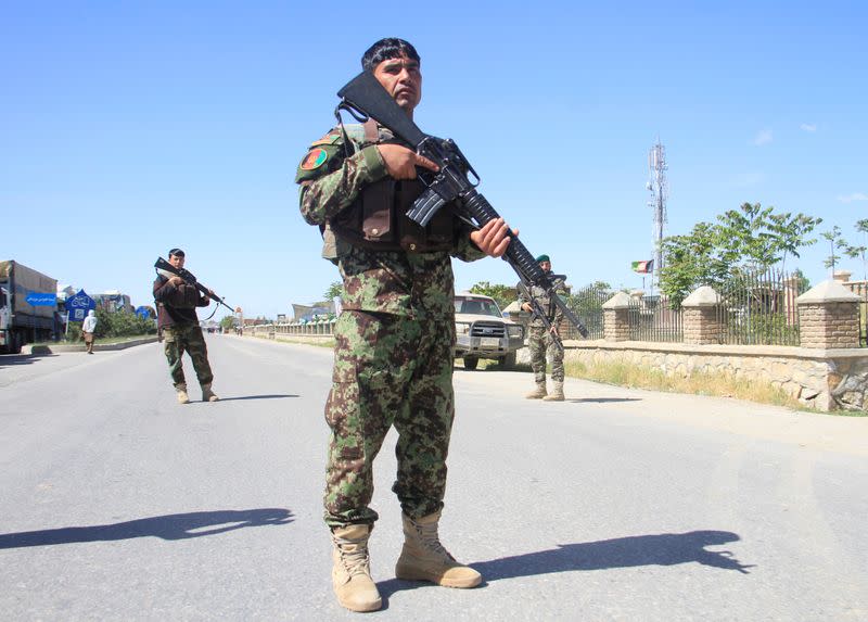 FILE PHOTO: Afghan National Army officers stand guard at the site of a blast in Ghazni province, Afghanistan