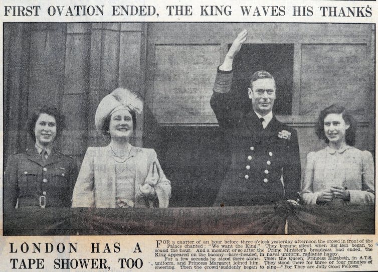 Newspaper picture of princess Elizabeth in army uniform with her parents and sister on a podium, smiling.