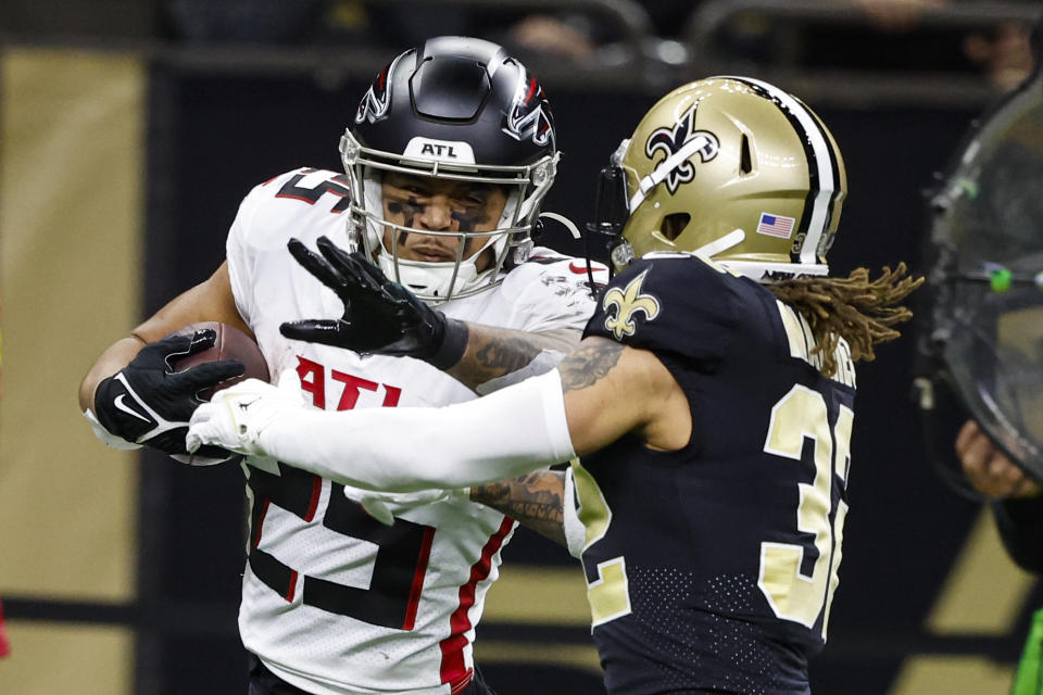 Atlanta Falcons running back Tyler Allgeier (25) is hit by New Orleans Saints safety Tyrann Mathieu (32) in the second half of an NFL football game in New Orleans, Sunday, Dec. 18, 2022. (AP Photo/Butch Dill)